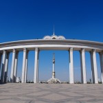 The Monument to Turkmen Independence and Peace, taken through the colonade of the Palace of Learning