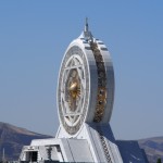 A huge gold and white marble ferris wheel. In the desert. Of course